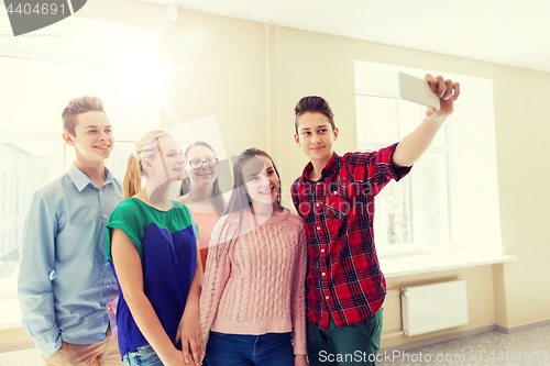 Image of group of students taking selfie with smartphone