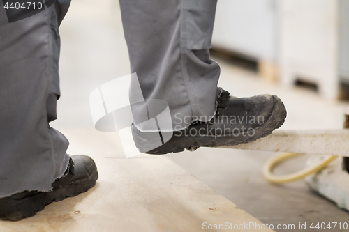 Image of close up of male worker feet in working shoes
