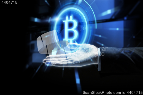 Image of close up of businessman hand with bitcoin symbol