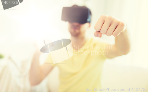 Image of young man in virtual reality headset or 3d glasses