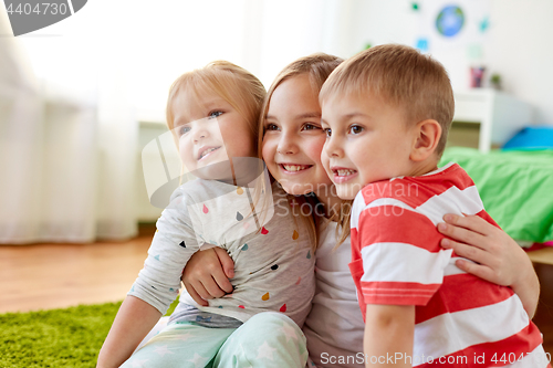 Image of happy little kids hugging at home