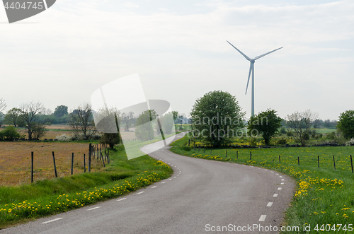 Image of Winding road by a windmill