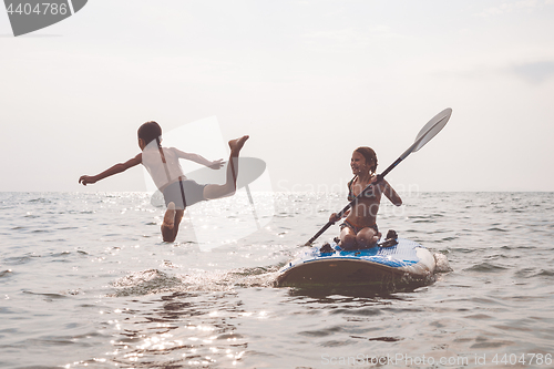 Image of Happy children playing on the beach at the day time.