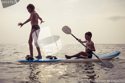 Image of Happy children playing on the beach at the day time.