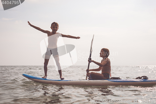 Image of Happy children playing on the beach at the day time.