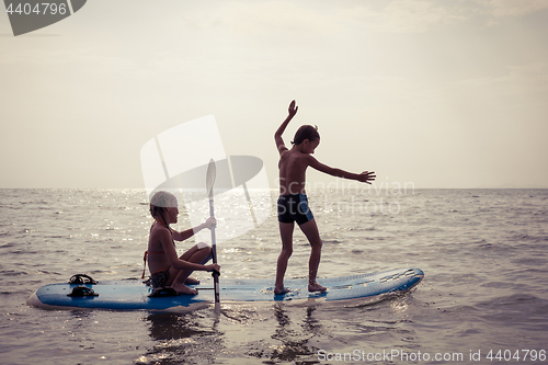 Image of Happy children playing on the beach at the day time.