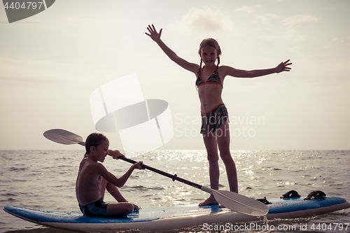 Image of Happy children playing on the beach at the day time.