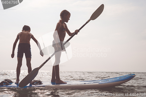 Image of Happy children playing on the beach at the day time.