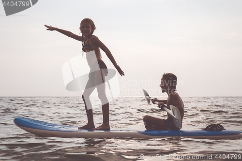 Image of Happy children playing on the beach at the day time.