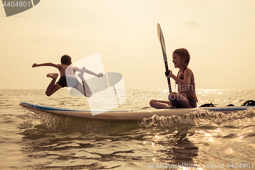 Image of Happy children playing on the beach at the day time.