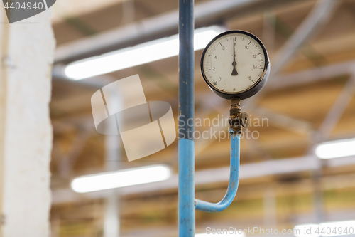 Image of old barometer at industrial plant
