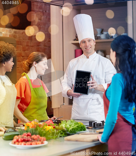 Image of happy women with chef and tablet pc in kitchen