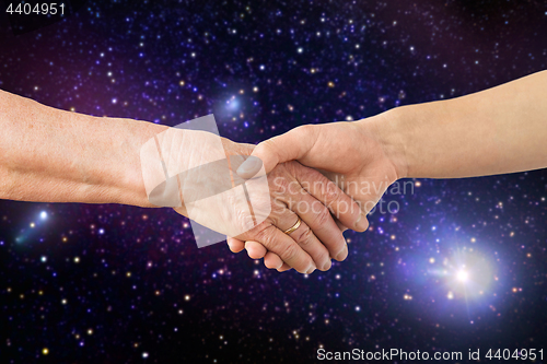 Image of close up of senior and young woman hands in space