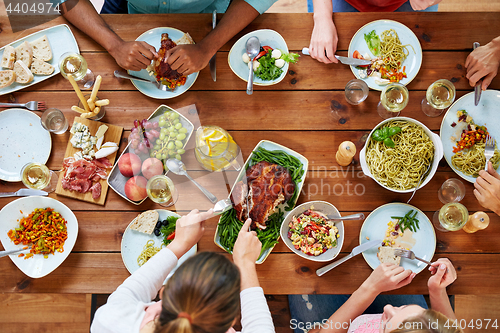 Image of group of people eating chicken for dinner