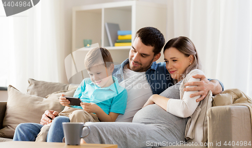 Image of happy family with smartphone at home