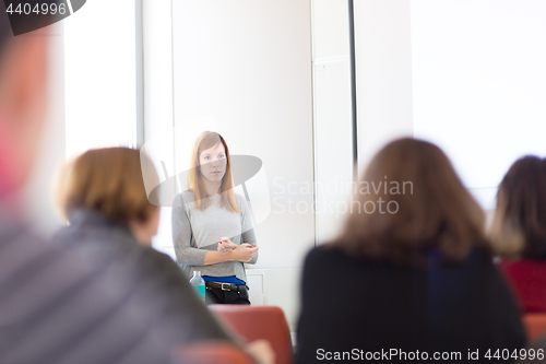 Image of Woman giving presentation in lecture hall at university.