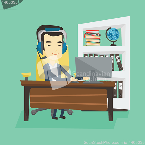 Image of Business man with headset working at office.