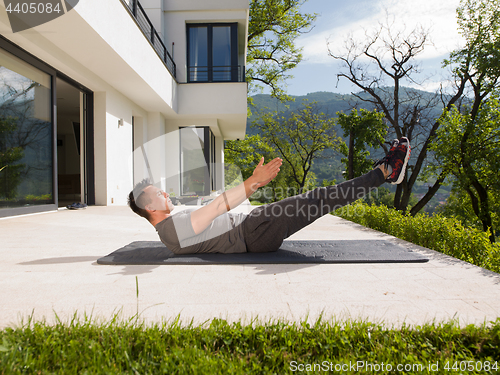Image of man doing morning yoga exercises