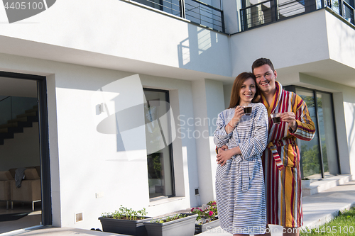 Image of Young beautiful couple in bathrobes