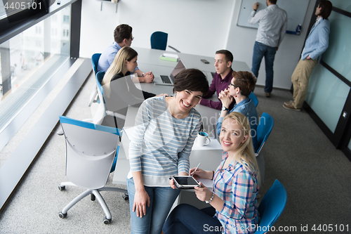 Image of Pretty Businesswomen Using Tablet In Office Building during conf