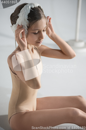 Image of Beautiful little ballerina wearing a white swan bandage on her head