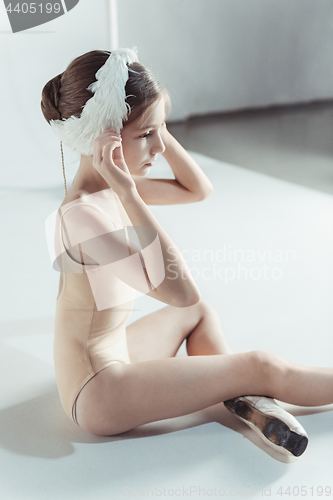 Image of Beautiful little ballerina wearing a white swan bandage on her head