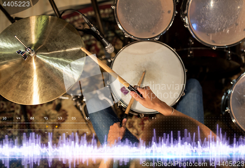 Image of drummer playing drum kit at sound recording studio