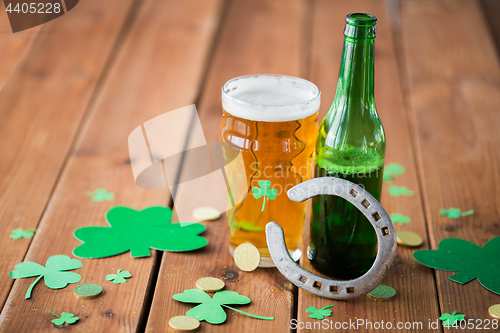 Image of glass of green beer, horseshoe and gold coins