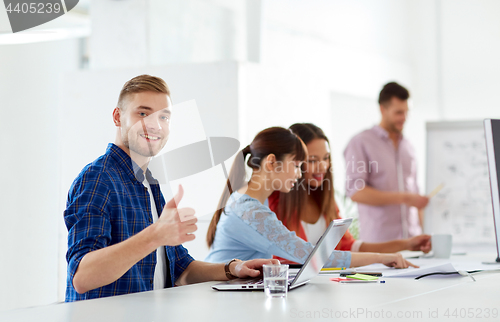 Image of happy man with creative team at office conference