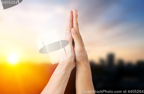 Image of close up of senior and young woman touching hands