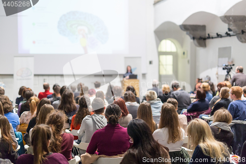 Image of Woman giving presentation in lecture hall at university.