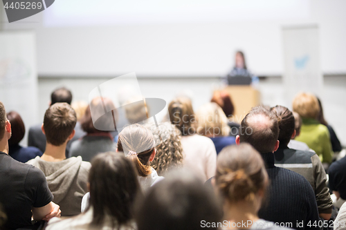 Image of Woman giving presentation in lecture hall at university.