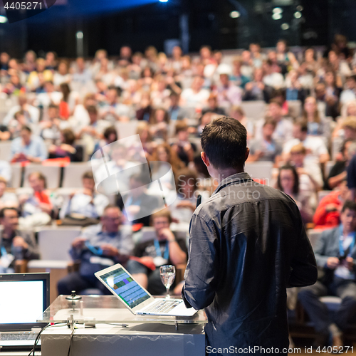 Image of Public speaker giving talk at Business Event.