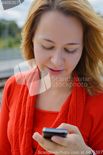 Image of Happy young caucasian girl with smart phone