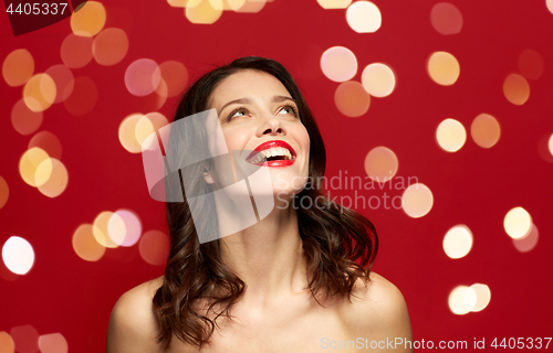 Image of beautiful smiling young woman with red lipstick