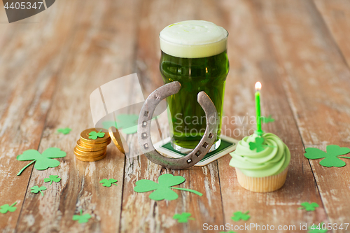 Image of glass of beer, cupcake, horseshoe and gold coins
