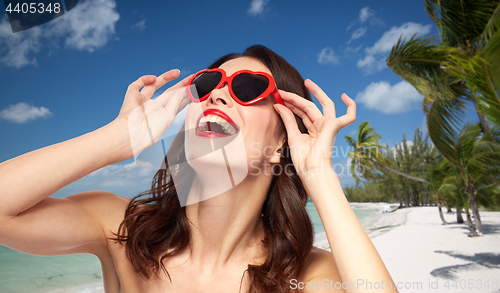 Image of woman with red lipstick and heart shaped shades