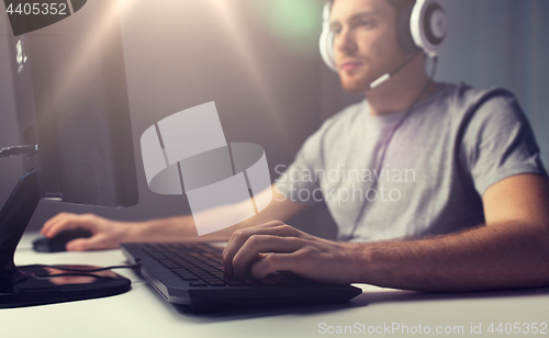 Image of close up of man playing computer video game