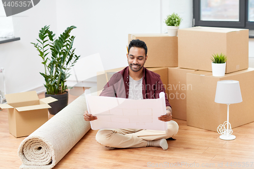 Image of man with boxes and blueprint moving to new home