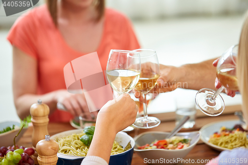 Image of hands clinking wine glasses