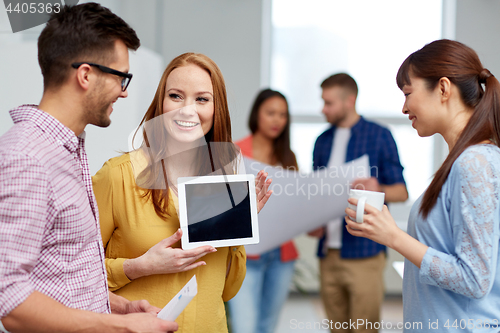 Image of creative team with tablet and coffee pc at office