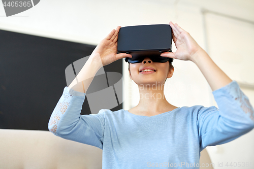 Image of happy woman with virtual reality headset at office