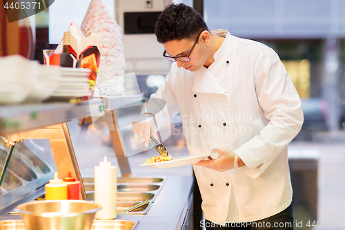 Image of chef with salad on plate at fast food restaurant