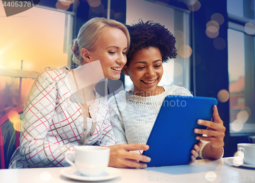 Image of happy young women drinking tea or coffee at cafe