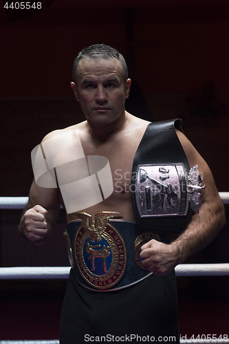 Image of kick boxer with his championship belt