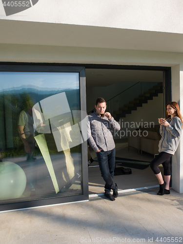 Image of couple enjoying on the door of their luxury home villa