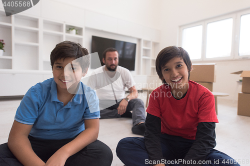 Image of portrait of happy young boys with their dad