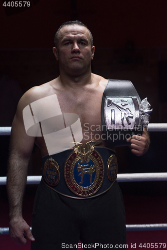 Image of kick boxer with his championship belt