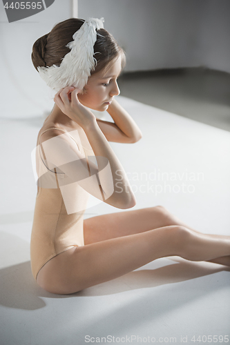 Image of Beautiful little ballerina wearing a white swan bandage on her head