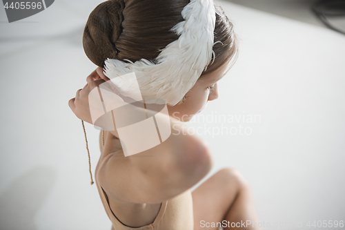 Image of Beautiful little ballerina wearing a white swan bandage on her head